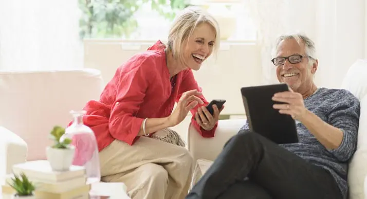 McLain Insurance Agency | couple laughing while looking at tablet and phone | Chesterfield, SC